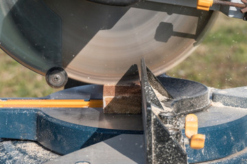 Roof construction building. Work on circular saw. Sawing wooden elements.