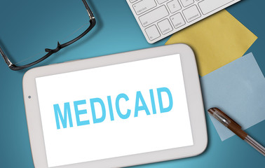 MEDICAID WORD ON WHITE TABLET