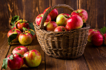 Naklejka na ściany i meble ripe red apples in a basket on the table