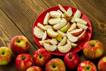 Naklejka na ściany i meble ripe sliced apples on a table in a plate sliced