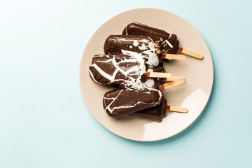 ice cream sundae in chocolate glaze in a plate bursting and melted