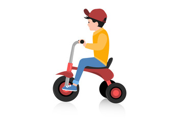 Boy riding tricycle on white