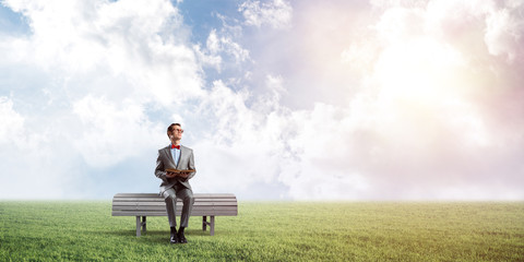 Young businessman or student studying the science in summer park