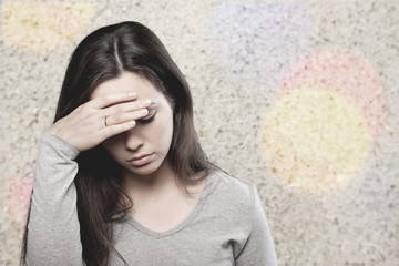 Young woman crying on background