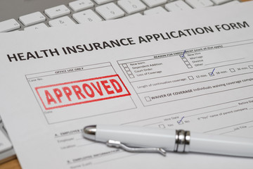 HEALTH INSURANCE APPLICATION FORM WITH RED APPROVED RUBBER STAMP AND WHITE PEN