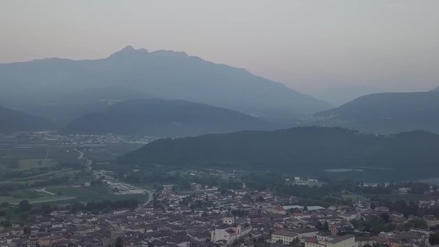 Aerial panoramic view of Levico Terme, Italy, during sunrise with drone panning left to right
