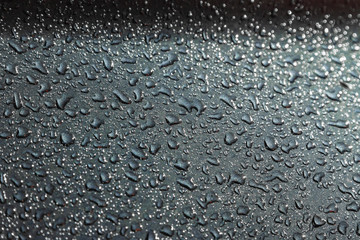 Rain drops on the surface of the car, abstract background