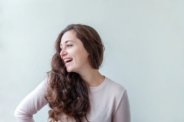 Naklejka premium Happy girl smiling. Beauty portrait young happy positive laughing brunette woman on white background isolated. European woman. Positive human emotion facial expression body language