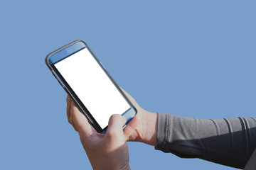 ISOLATED HANDS OF WOMAN USING BLUE SMARTPHONE WITH BLANK WHITE SCREEN AND BLUE BACKGROUND FOR ADD WEB PAGE, TEXT, OR IMAGE