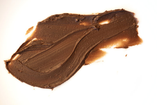 Delicious chocolate frosting spread on surface.