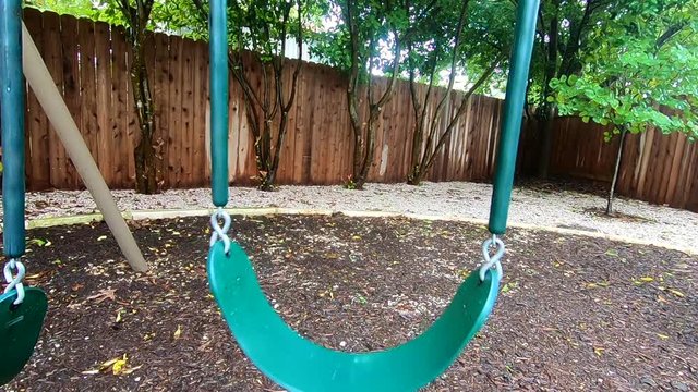 A lonely swing floats in the fall cool weather.