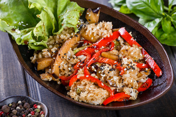 Rice with vegetables and sesame seeds on wooden table.Indian cuisine