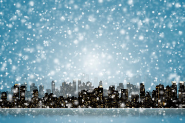 NIGHT VIEW SILHOUETTE OF NEW YORK / MANHATTAN WITH SNOW FALLING FROM DARK BLUE SKY