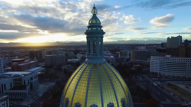 4k aerial drone footage.  Golden dome of Colorado State Capital at sunset.  City of Denver