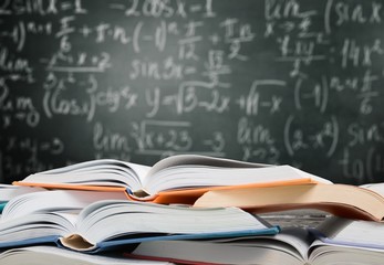 Heap of open books at school room