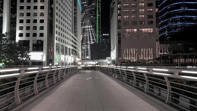 guangzhou modern city at night, b-roll, 4k, aerial and street height walkthrough. modern skyscrapers illuminated with LED lights showing success of this major world city from illuminated walkway