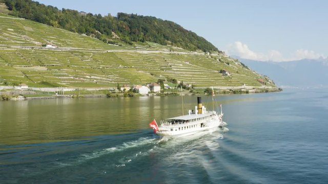 Aerial shot passing behind CGN steam Belle-Epoque ship on Lake L&radic;&copy;man in front of Lavaux. The Alps in the background
Cully, Vaud - Switzerland