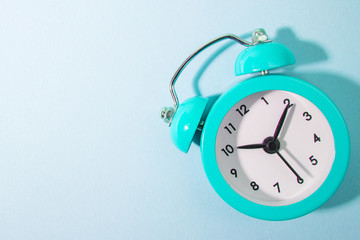 Blue background and blue alarm clock