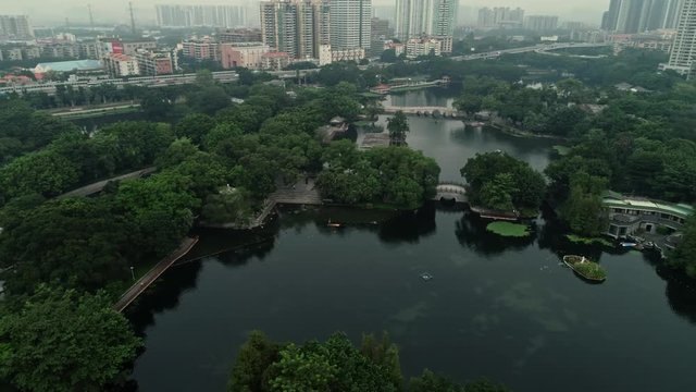 Liwan is the original city of Guangzhou, comprises old buildings and a canal system. Fly through and over the canal and see Liwan natural park, daylight, 4k, d-log, b-roll