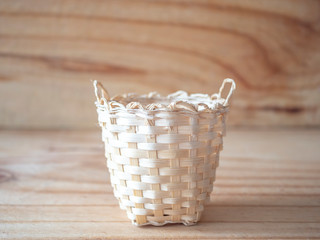 Fototapeta premium Bamboo basket on wooden texure