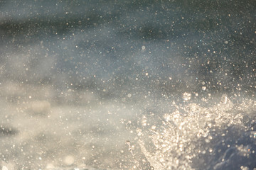 Blue ocean water with splashes and foam
