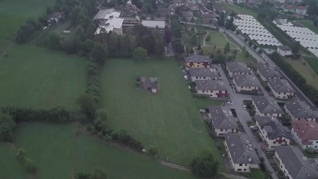Aerial reveal type clip of Levico Terme, Italy, during sunrise with drone flying forward