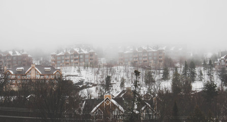 Fototapeta na wymiar winter mountain landscape with houses and trees