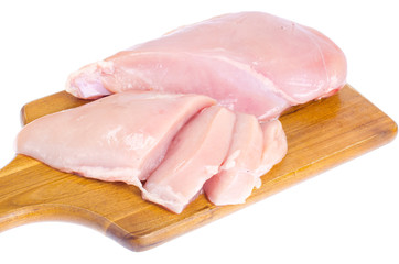 Chicken fillet on kitchen wooden cutting board
