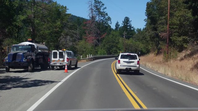 Multiple views of California road construction at different times of day with shadows, full sun and typical traffic management approaches.  Different vehicles used in road repair.