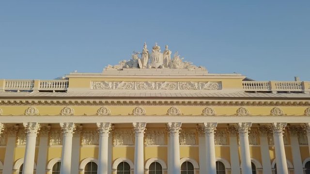 Russian Museum aerial shot with colomn view on a main building with sun setting down, going up with a city panorama