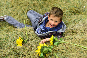 Naklejka na ściany i meble Happy childhood time. Happy boy. Little boy happy smiling in hay. Little child on farm. Play is the work of childhood