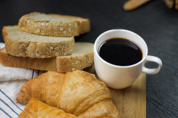 black coffee for healthy  and bread with Croissant , Pie in the wood in the morning.