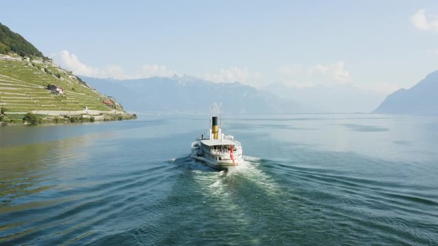 Aerial shot following CGN Belle-Epoque steam boat on Lake L&radic;&copy;man in front of Lavaux vineyard.
Switzerland