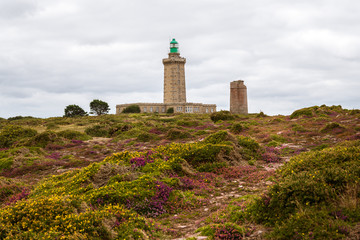 Fototapeta na wymiar Lighthouse of Cap Frehel on a cloudy day in summer