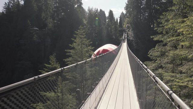 Walking on empty suspension bridge with Canadian flag