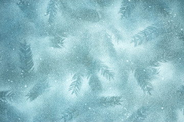 winter holiday background, frozen snowy surface with fir tree branches imprints