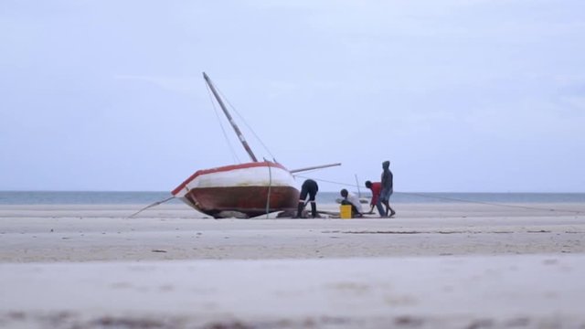 Local Fishermen Fixing Boat on the Shoreline, With Sea on Distant Horizon - Scene 2