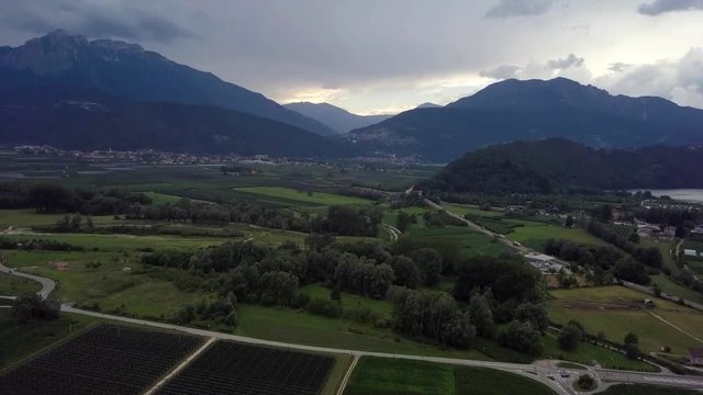 Aerial panoramic view of Levico Terme, Italy, during sunrise with views of the mountains.