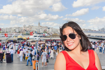Beautiful woman poses with view of Galata Tower
