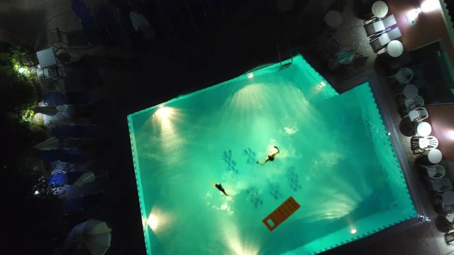 Jumping In Pool At Night From Above