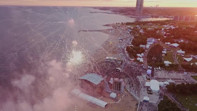 VK Fest, festival fireworks close up view with people on a stage and Lakhta center in the background in Saint-Petersburg