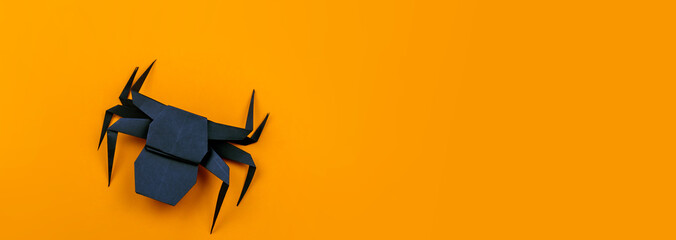 Origami Halloween. Black spider made of paper