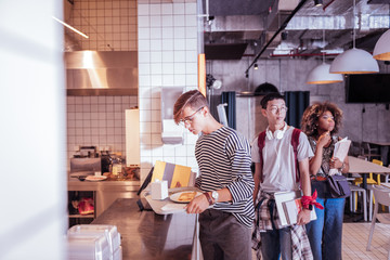 My term already. Attentive boy bowing head while looking at his food for dinner