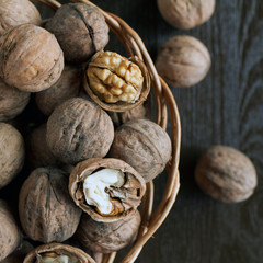 greek nuts in a basket on a wooden background