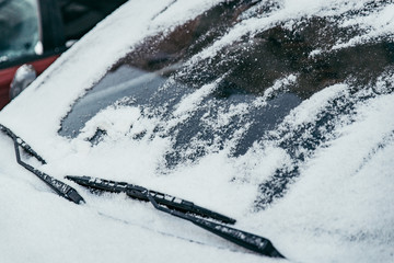 car covered with snow on outdoors parking in winter day
