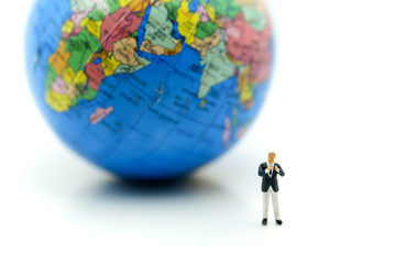 Miniature people : Businessman with mini world using for concept of International Men's Day.