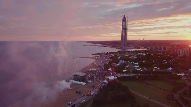 VK Fest, festival fireworks close up view with people on a stage and Lakhta center in the background in Saint-Petersburg