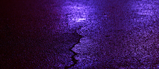 Background of wet asphalt with neon light. Blurred background, night lights of a big city,...