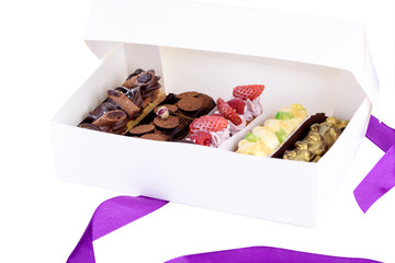 A box of delicious desserts. Eclairs with different fillings. Delicious desserts in the packaging box.