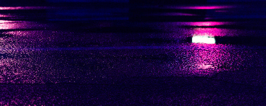 Background of wet asphalt with neon light. Blurred background, night lights of a big city, reflection, puddles. Dark neon bokeh. © MiaStendal